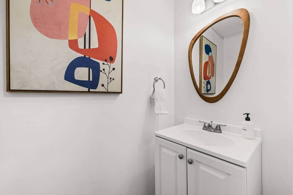 The downstairs half bath is convenient to the kitchen, living room, dining area, and backyard, saving a trip upstairs during the day. Hand soap, towels, and toilet paper are provided. Two additional full bathrooms serve the upstairs bedrooms