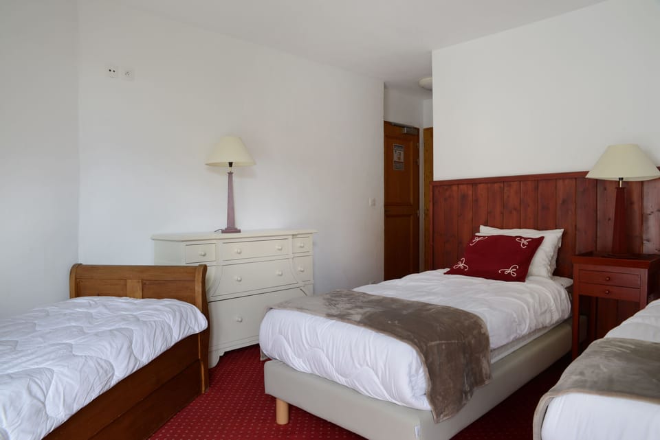 win bedroom with wood furnishings and chalet-style decor.