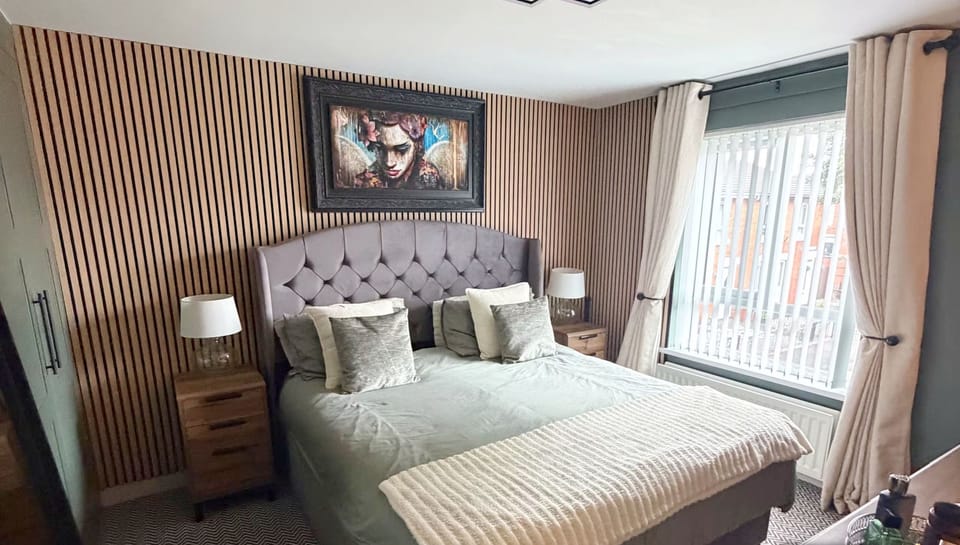 The master bedroom features a comfortable kingsize bed, a television, and built-in storage for your convenience.