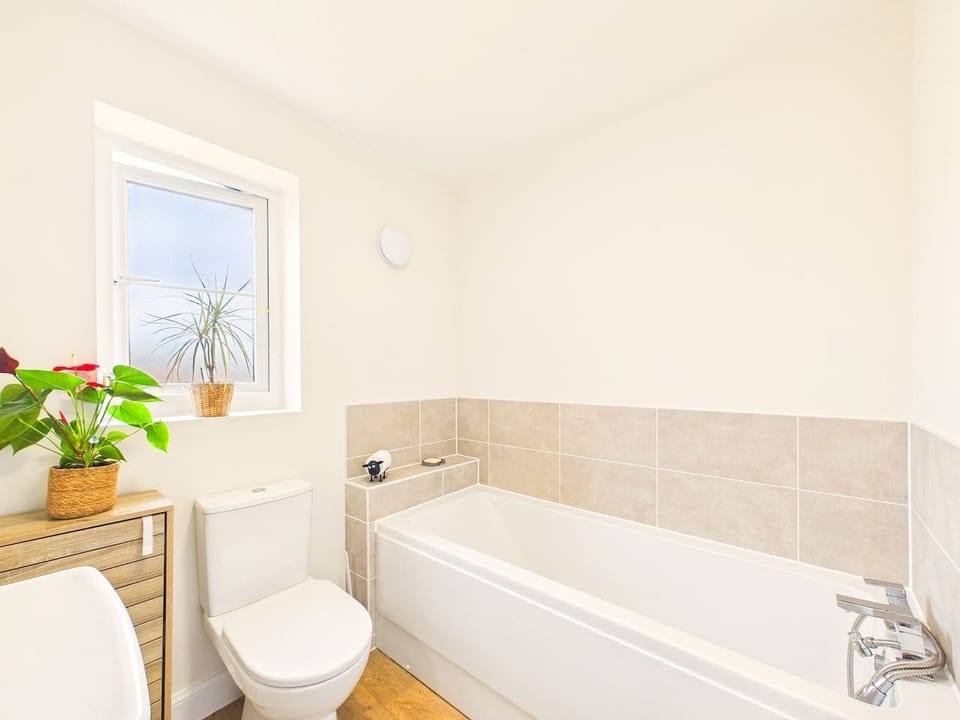 Fresh, light-filled family bathroom with a full-size bath for a long soak after a day exploring Wigan and beyond.
