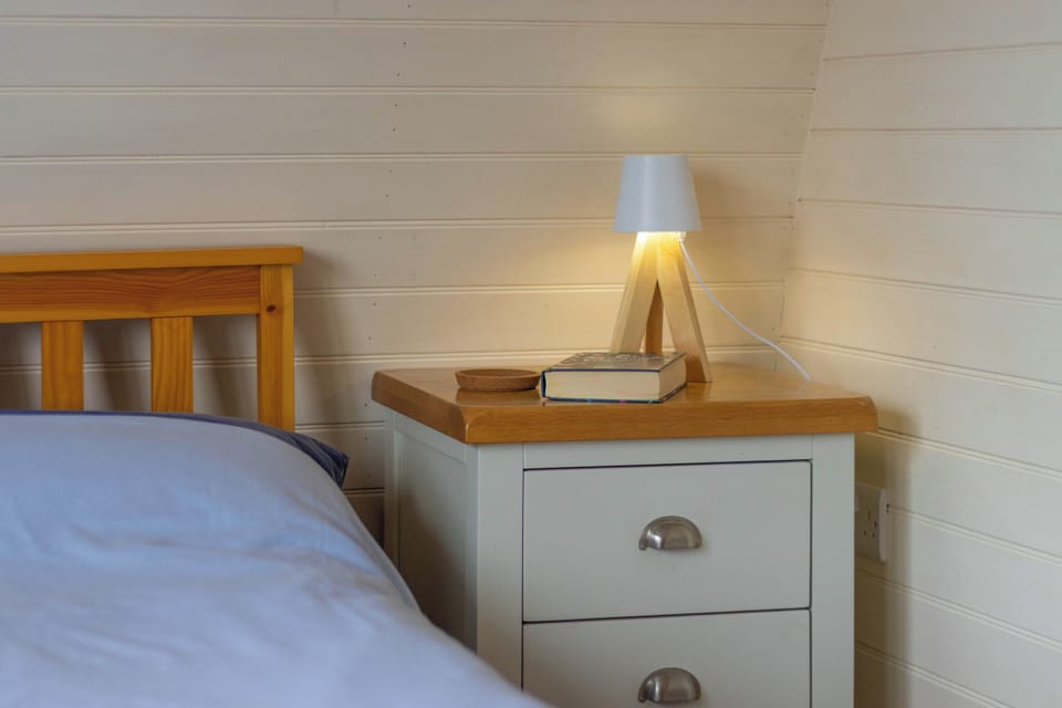 Keep evening essentials close at hand beside the comfortable double bed, with gentle lighting helping you unwind and ease into a restful night.