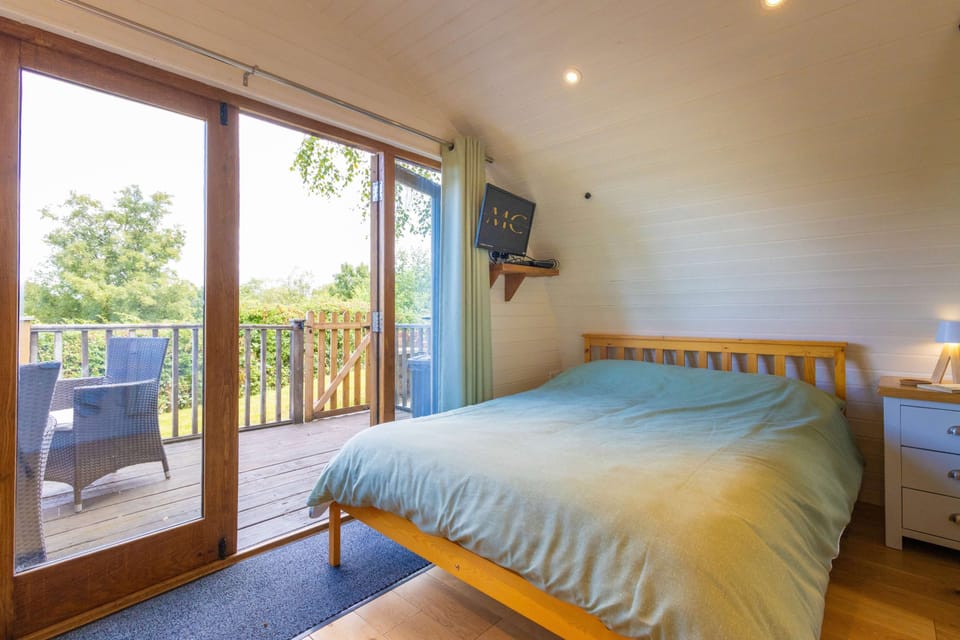 Rest comfortably beside wide patio doors, waking to natural light and the promise of another relaxing day exploring beautiful Mid Wales.