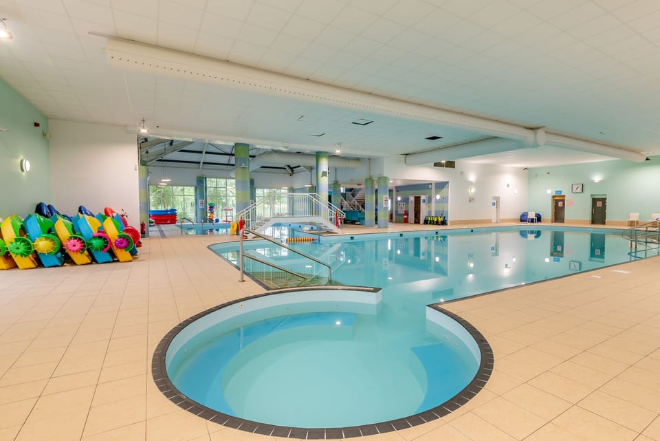 Bright indoor pool with separate shallow pool and family-friendly amenities