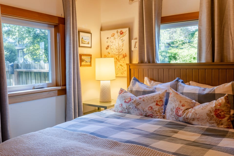 Queen bedroom with warm coastal character and comfortable accommodations for two.