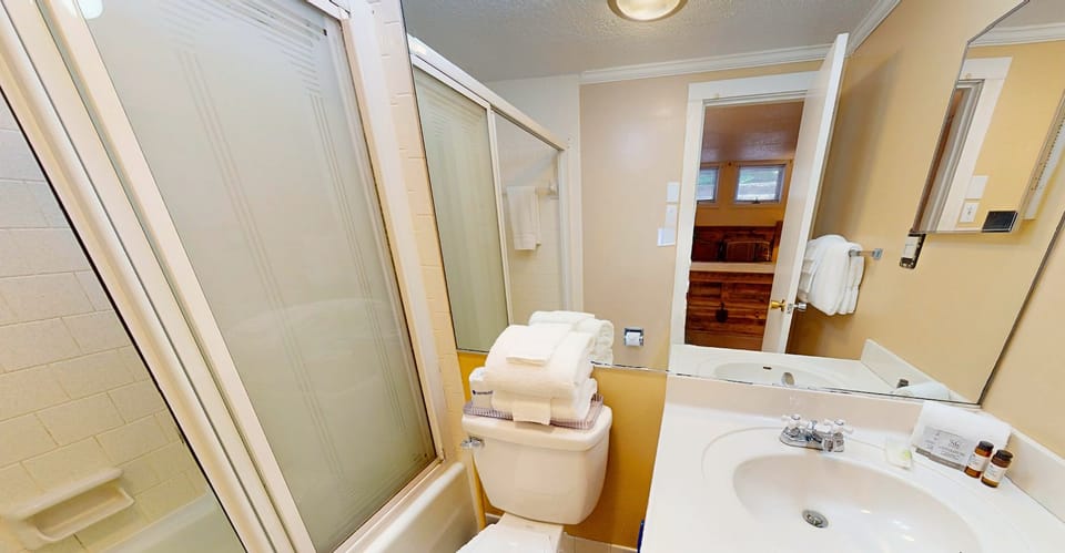 Step into your private bathroom with everything you need. Fresh towels, a roomy vanity, a shower, and thoughtful touches to make your stay feel like home.