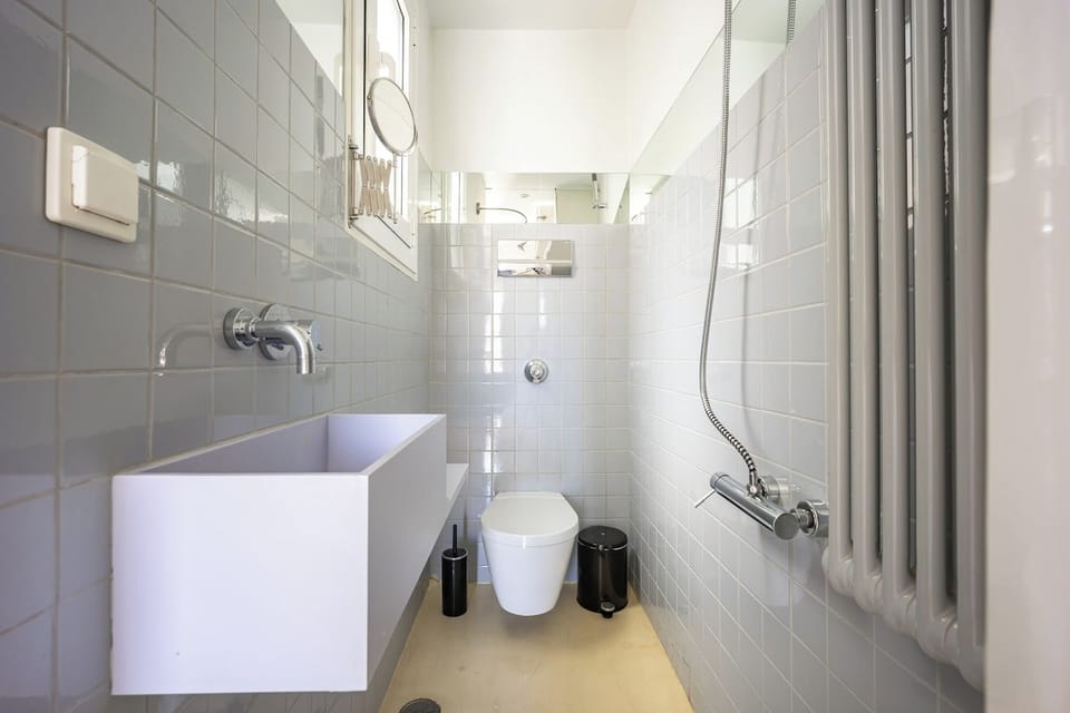 Modern WC with white tiles.