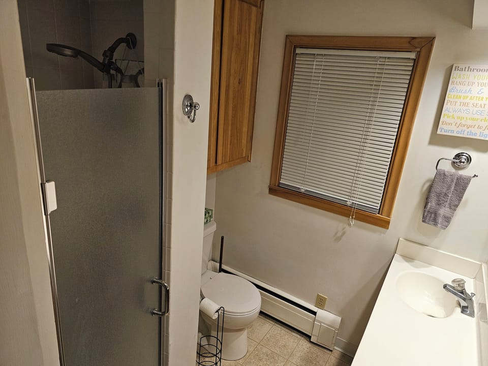 Bathroom with 2 sinks, shower, and toilet