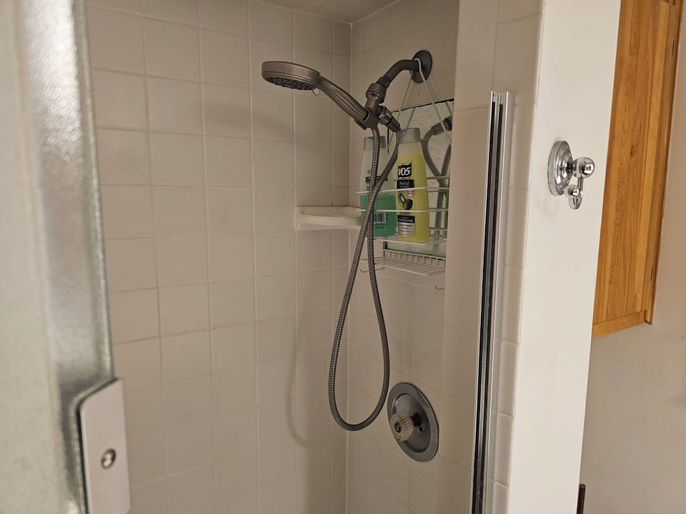 Bathroom with 2 sinks, shower, and toilet