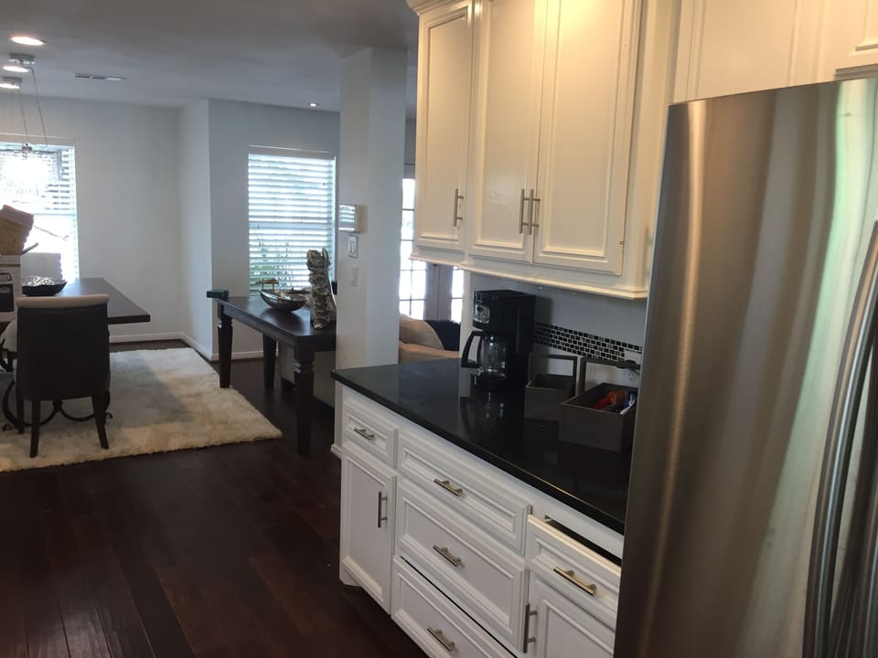 Full kitchen with fridge, dishwasher, sink, and all plates and cooking equipment
