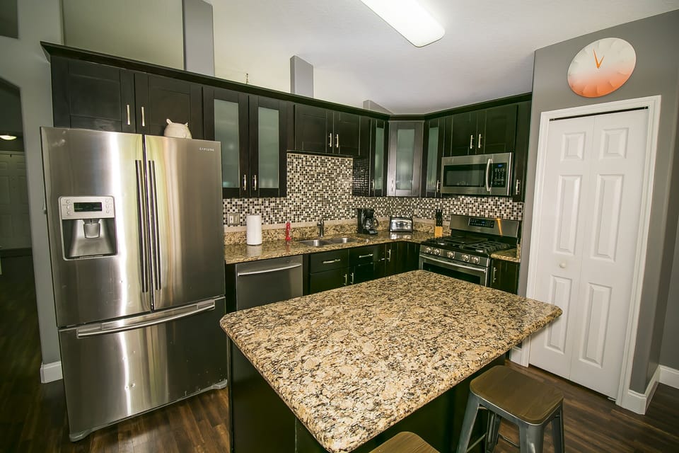 Beautifully upgraded kitchen with stainless steel appliances and granite counter