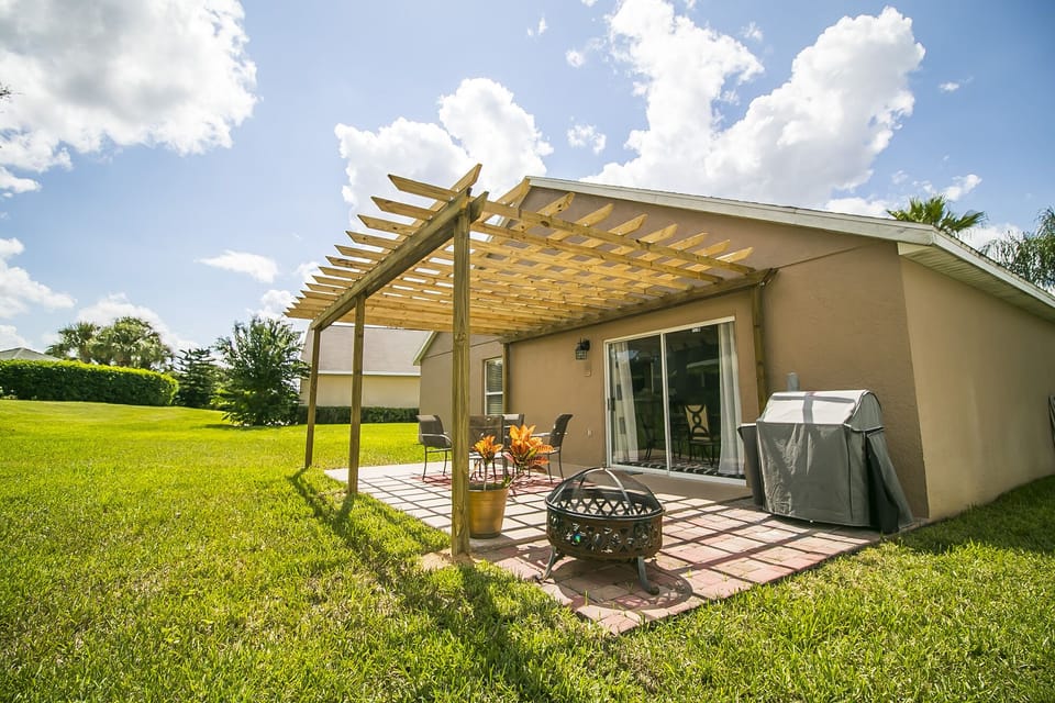 Outdoor seating with grill and covered pergula. 