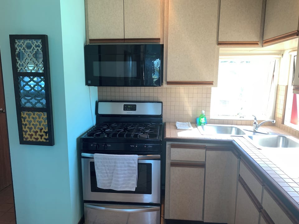 kitchen is equipped w/full size fridge, gas stove, convection oven, double sinks