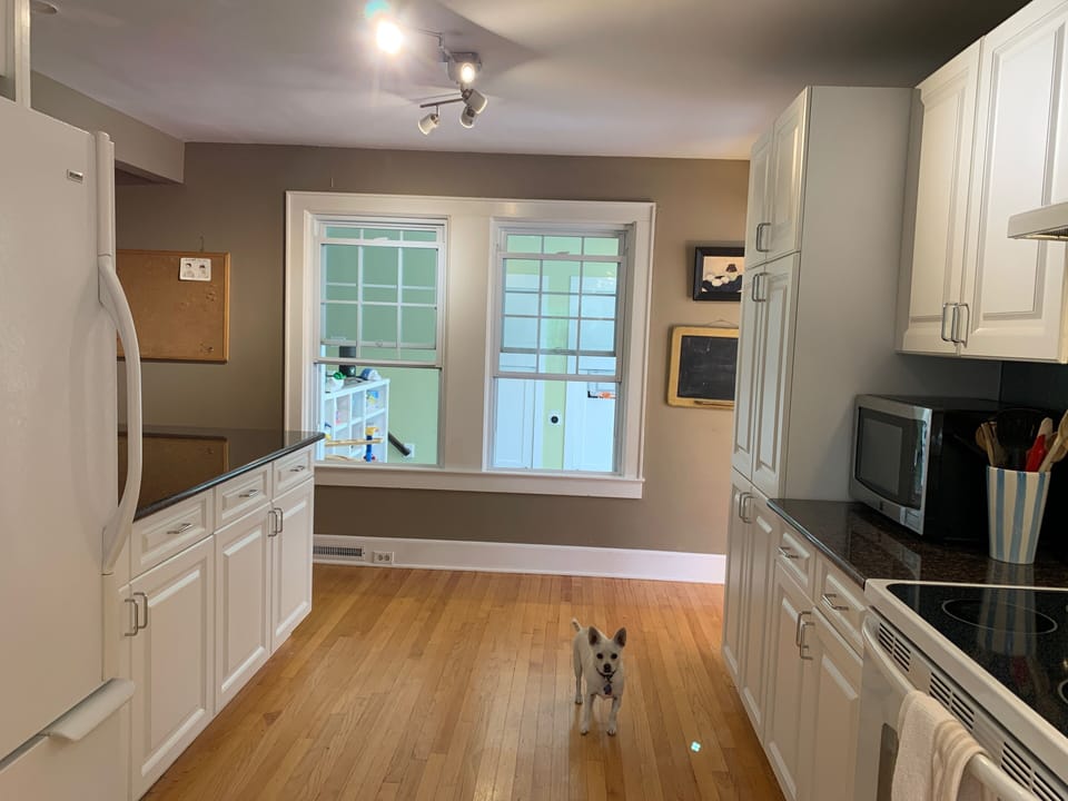 Windows in kitchen overlook playroom