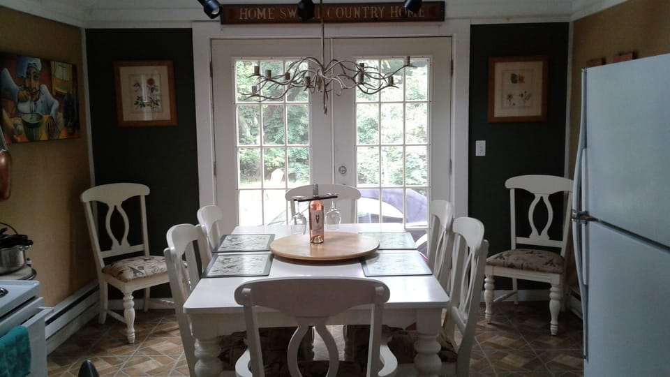 A country kitchen provides seating for 8.  Home sweet country home!