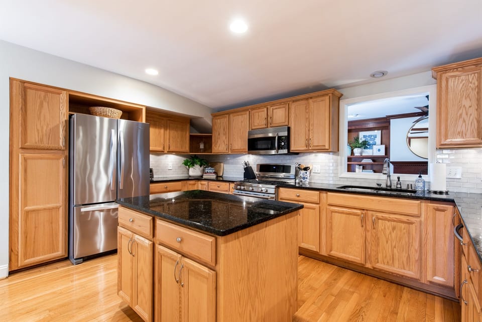 Upscale appliances with dual ovens, refrigerator with water in the door, microwave, dishwasher, and Keurig Duo. Includes all dishes and glassware with seating for 6.