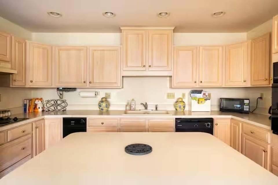 Kitchen with large island with bar seating for three. 