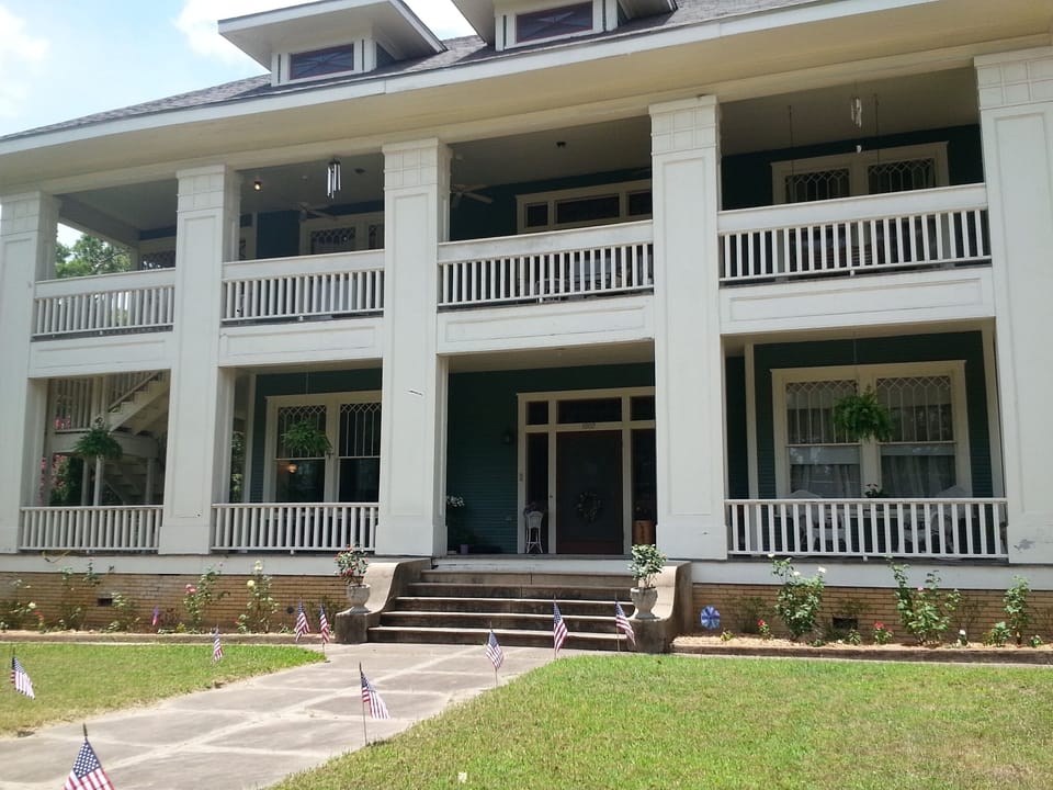 Street view of Historic Hole House on half acre lot, near downtown.
