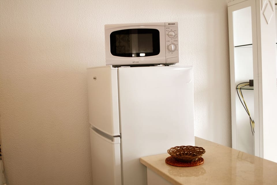 Microwave and Frige with Freezer.