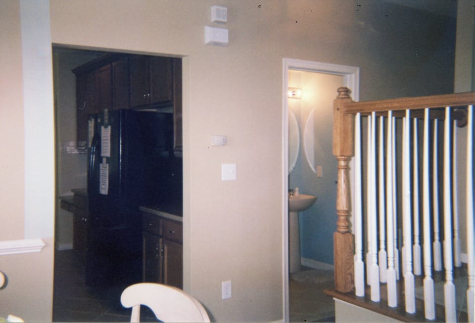 View of hall, powder room and kitchen from living room