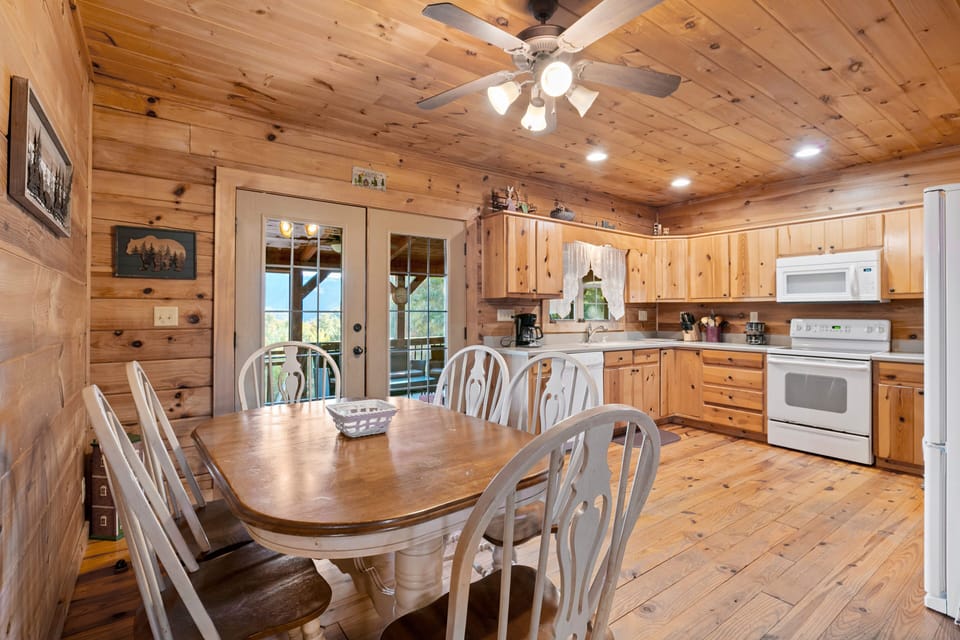 Dining area with kitchen in the background