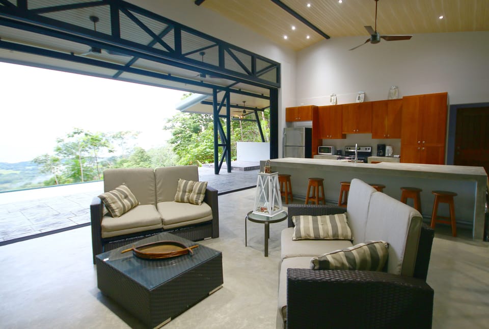 Living area with sliders opened to the terrace/pool
