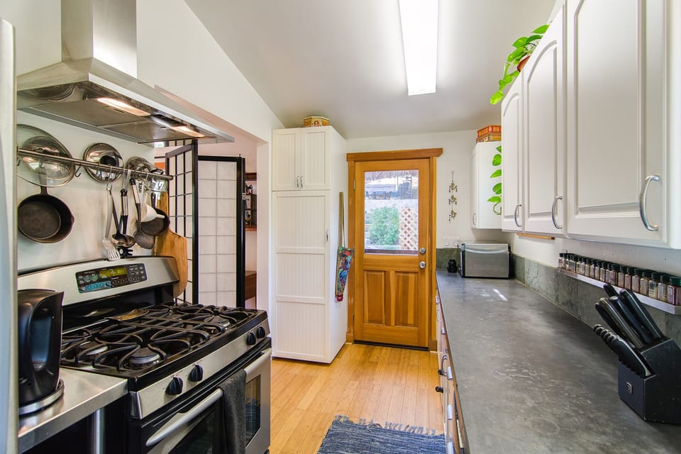 Kitchen door to back yard affords climatic flow to enjoy your meals al fresco.