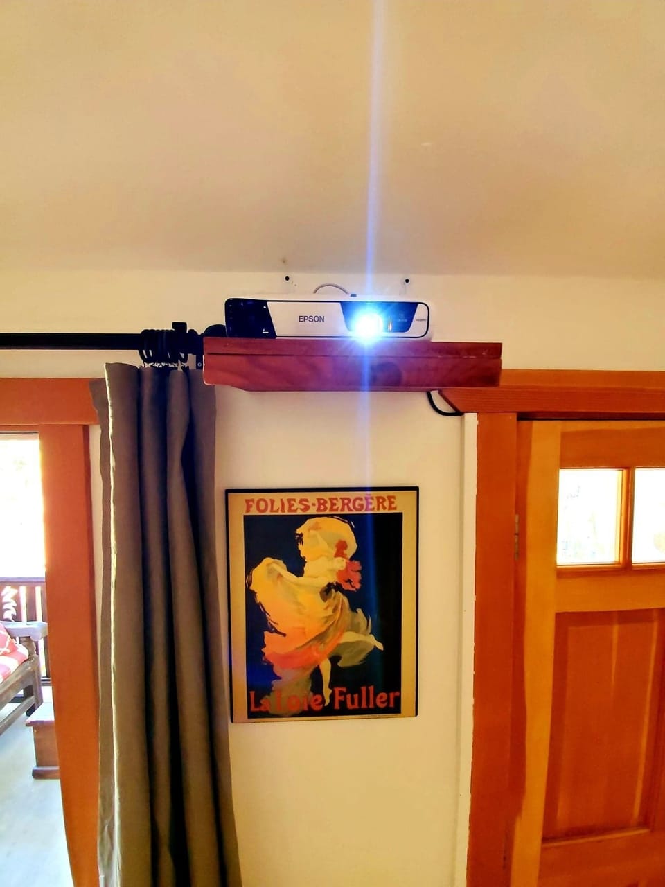 French vintage artwork topped by projector, only visible electronic in the room.