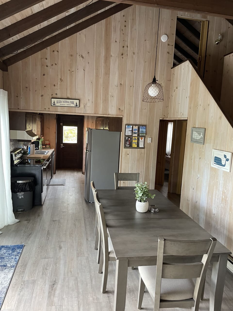 dining area to galley kitchen with two bedrooms and bath to the right