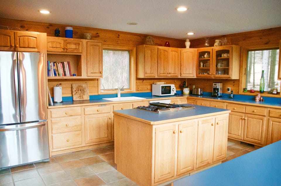 Modern, open-plan kitchen with island and  stainless steel appliances