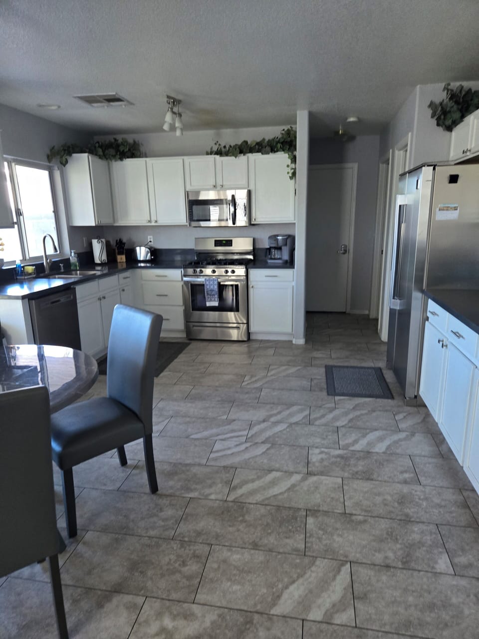 kitchen, kureig and drip coffee maker,oven, refrigerator, stove, dining table