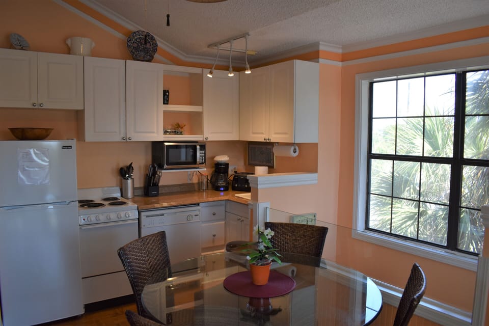 Kitchen/dining table. Entry stairs on right (photo taken before updates)