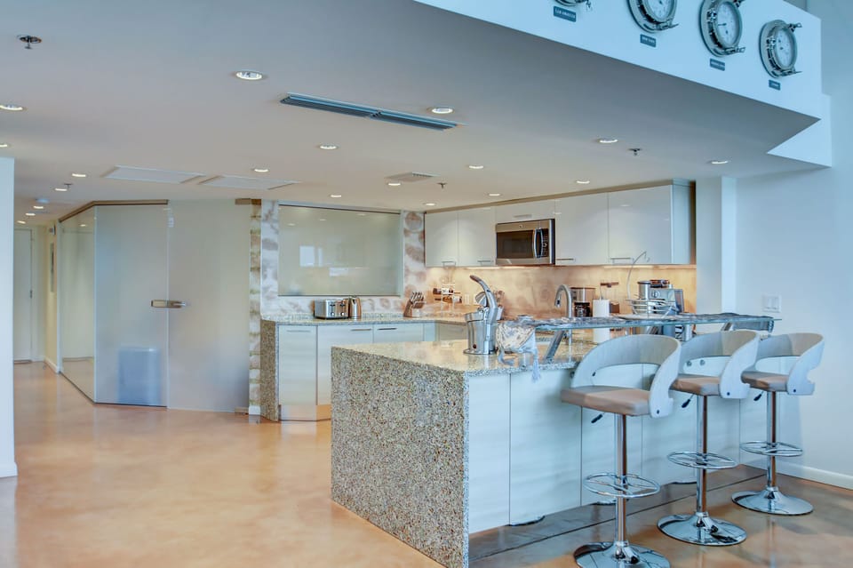 Opened American Kitchen and Guest Bedroom with low iron glass walls