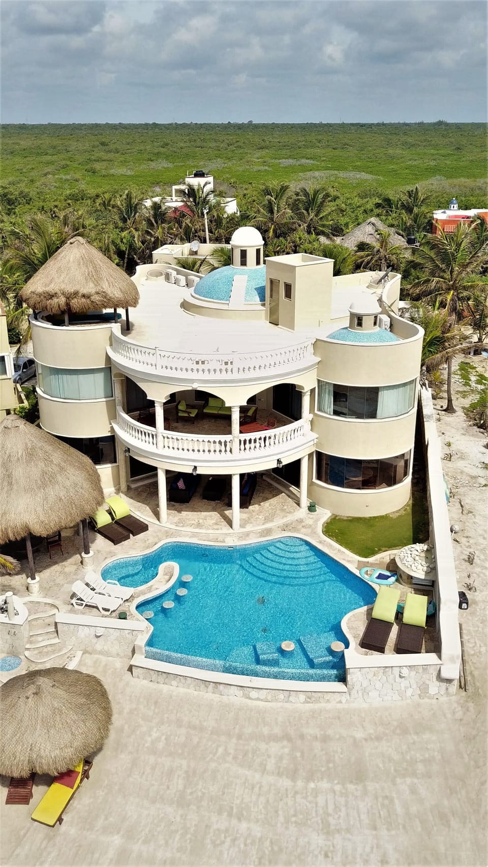 Aerial view of Villa Escapar from the white sand beach behind the villa