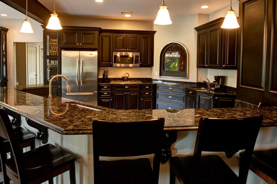 Gourmet Kitchen fully equipped, granite counters, counter seating and fireplace