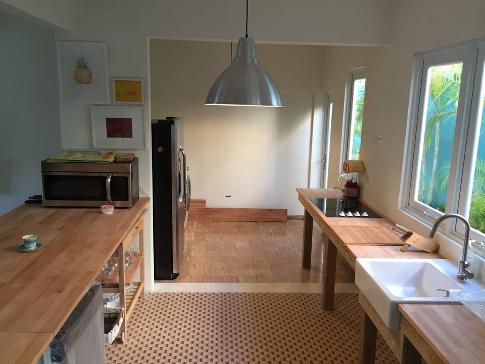 Kitchen from dining room, with washer/dryer area behind refrigerator