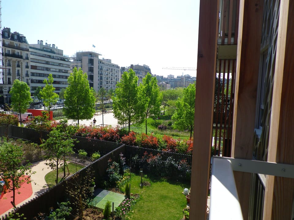 View of Adjacent Eco-Friendly Park and Neighborhood from Balcony
