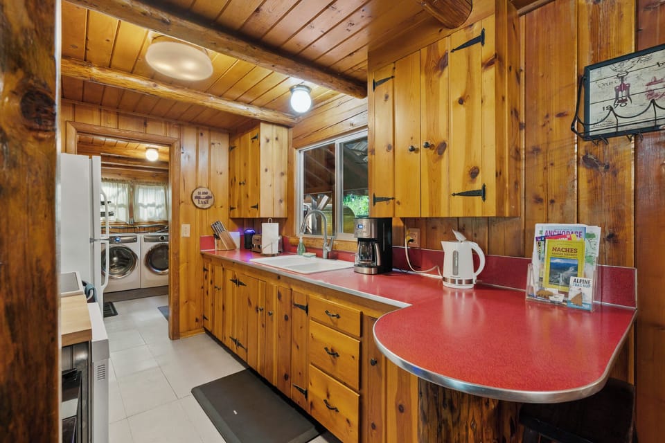 Fully stocked kitchen with dishwasher, microwave, range, and fridge/freezer