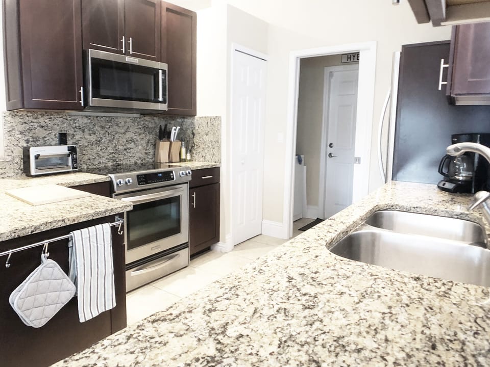 Fully stocked kitchen with granite countertops and Kitchen Aid appliances,