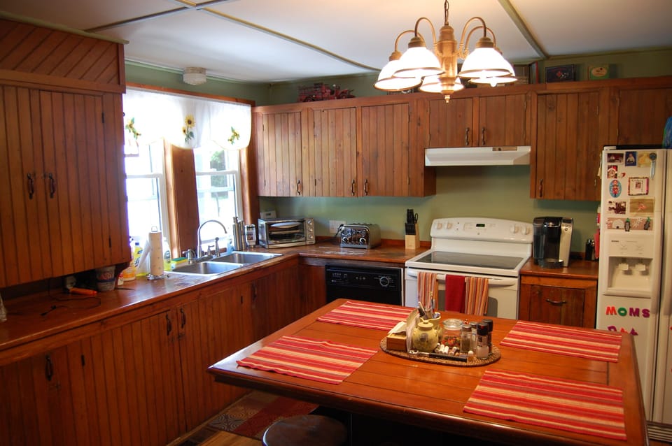 New England kitchen charm with center island w/ stools