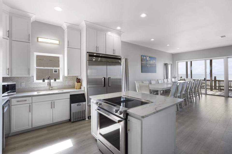 Extra large refrigerator, under counter ice maker, island stove and oven.