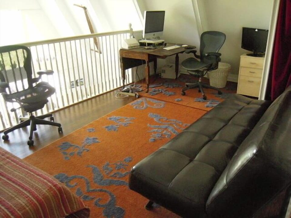 study with pull out leather couch and  a pull size bed