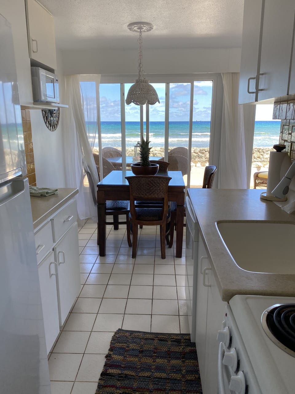 Complete kitchen with dining table and dishwasher.
