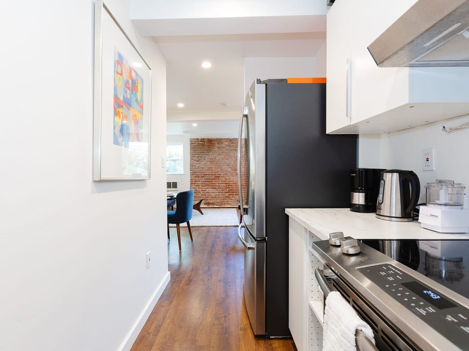 Fully equipped kitchen with large size appliances, refrigerator, range and oven.