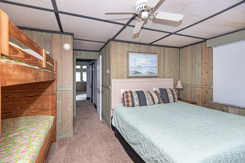 Bedroom with king bed and bunk beds.