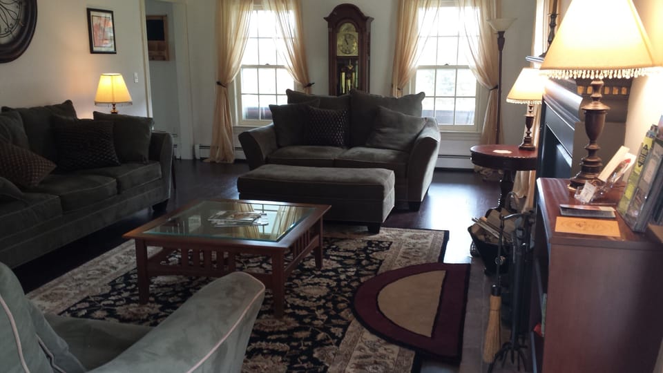 Large living-room w/ cozy couches and wood-stove
