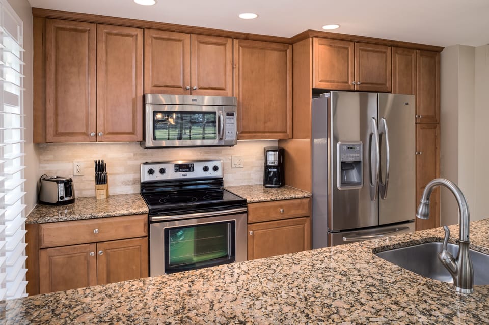 Gourmet kitchen with granite counter tops and stainless steel appliances