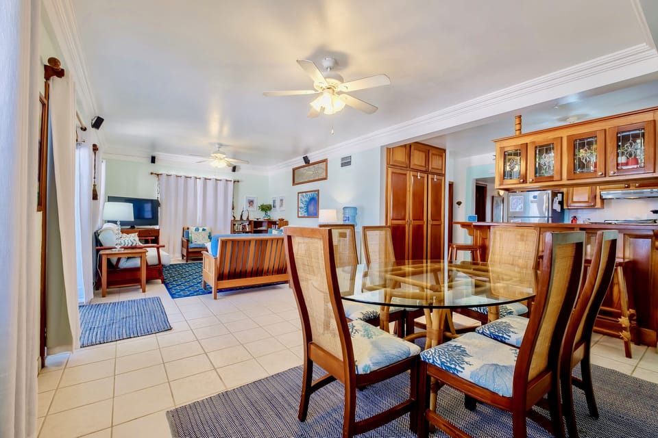 Dining area with view to living room; double doors to porch on left