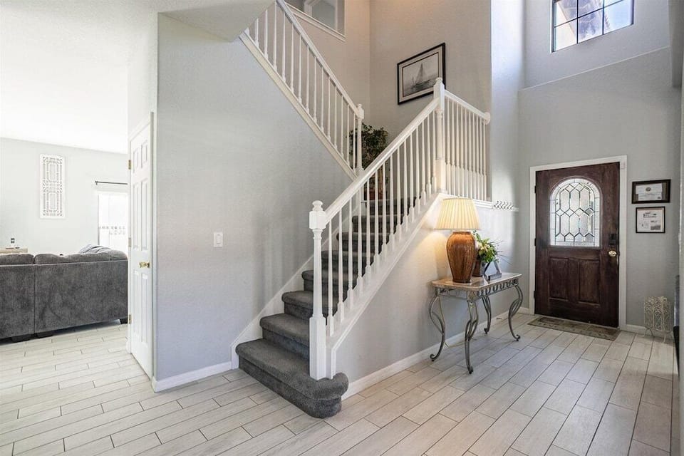 Elegant staircase leading to spacious upstairs living areas.