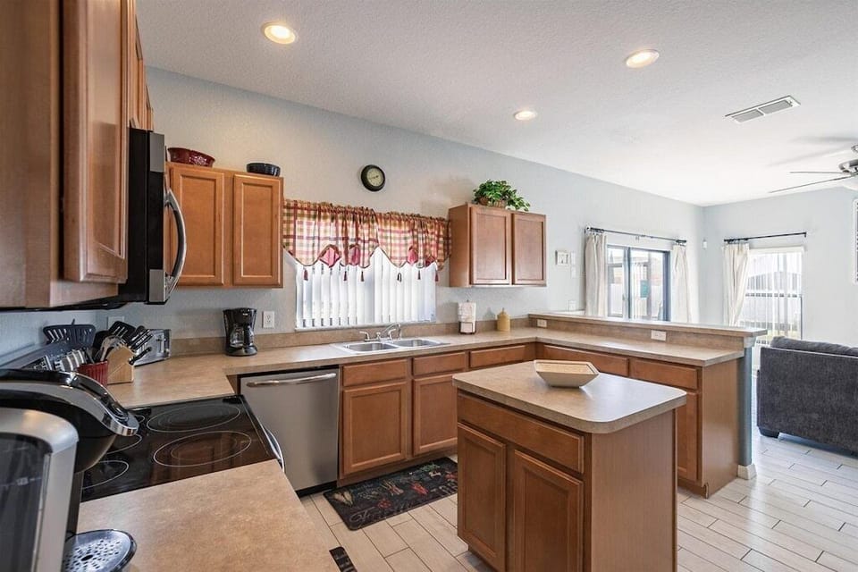 Spacious kitchen with stainless steel appliances and a cozy breakfast nook.