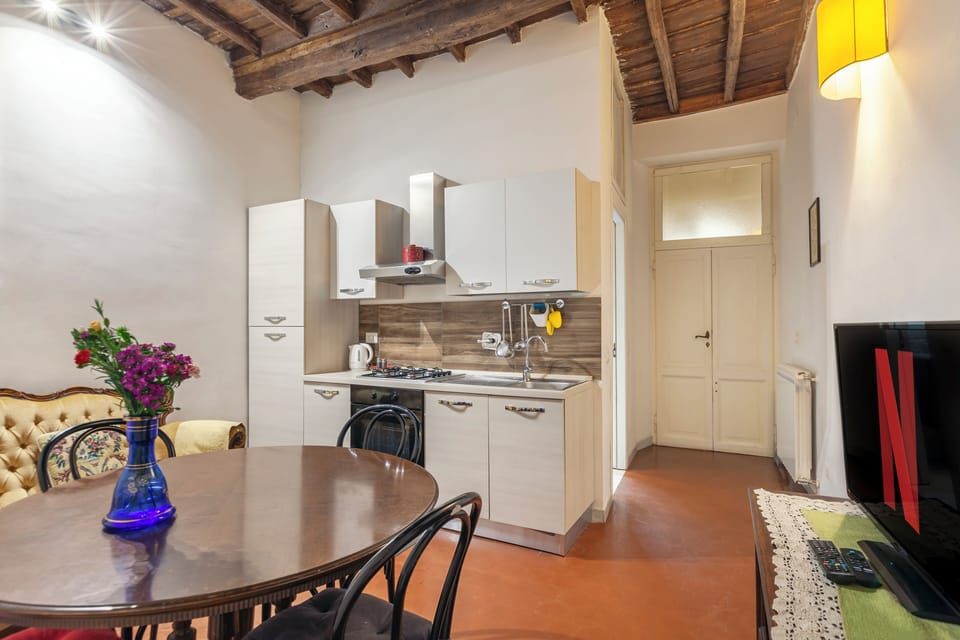 Fully equipped kitchen and living–dining area.